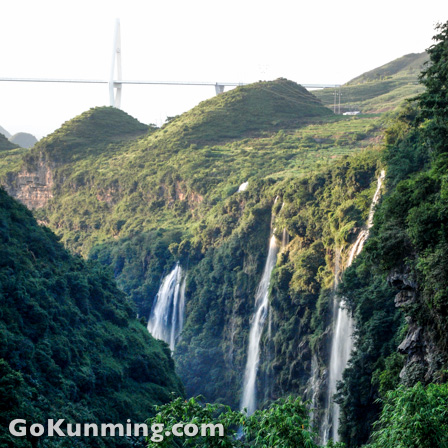 In the distance, the Baling River Bridge towers over the landscape.