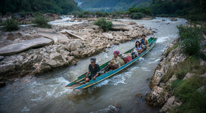 A boat speeds down a channel of the Nam Ou. This section of river will be inundated by the construction of one of many large dams on this river (photo credit: Will Stauffer Norris)