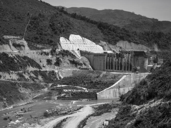 A monolith of a dam wall rises. It is one of seven Chinese-constructed dams along this important Mekong tributary, the Nam Ou (photo credit: Kyle Seewald Hemes)
