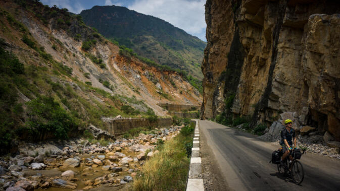 Will cruising between cliff and stream on the long descent to the Red River in Yunnan province, China (photo credit: Kyle Seewald Hemes)