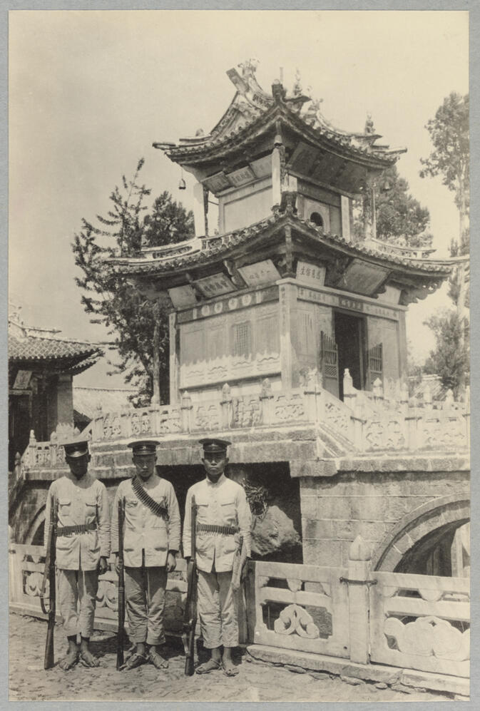 Three soldiers in front of ornamental building April 15, 1922