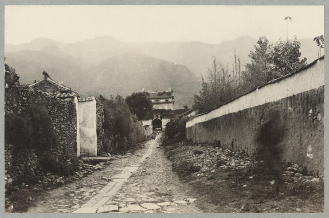 Path by wall leading toward gate May 3, 1922
