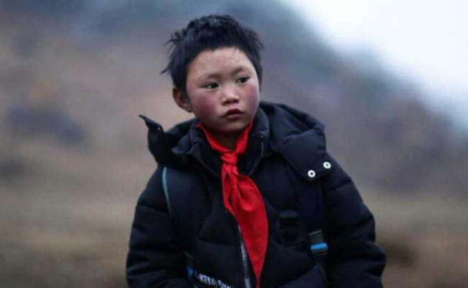 Wang Fuman, China's "Ice Flower Boy", sporting newly donated and much warmer clothes