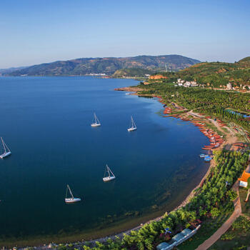 Sailboats moored just off the shore of Fuxian Lake in China