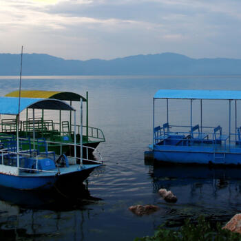 Paddle boats bob along the shore of Fuxian Lake