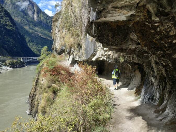 The Tea Horse Trail at the gorge at Wuli. In the background three generations of bridges across the Nujiang.