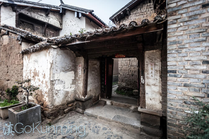 The well-worn front gate of a house on Ximen Jie