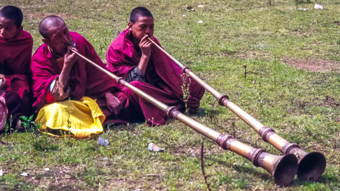 Monks playing horns during Rounding the Mountain Festival
