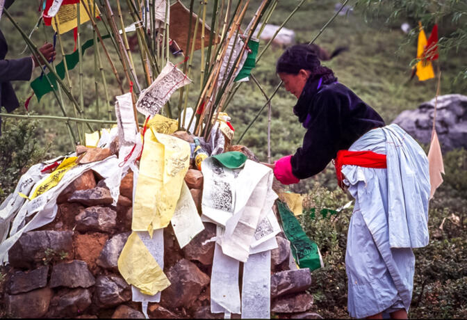 Tying prayer flags at Ganmo's shrine